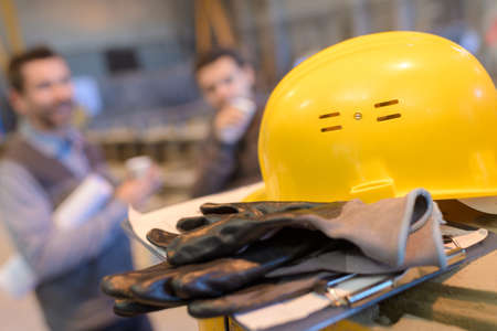 yellow construction helmet and gloves isolated on white backgroundの写真素材
