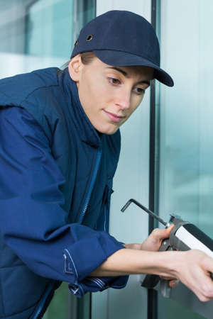 fixing the crack on the windowの写真素材