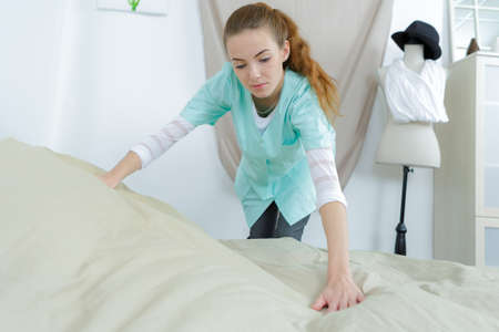 maid making bed in a nursing homeの写真素材