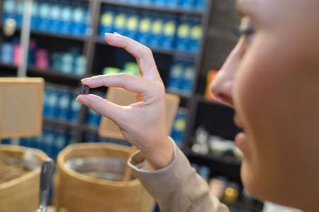 female hand holding a coffee beansの写真素材