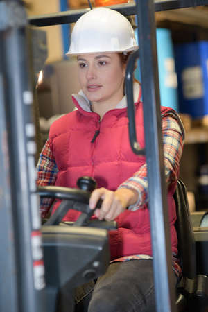 female fork lift truck driver in factoryの写真素材