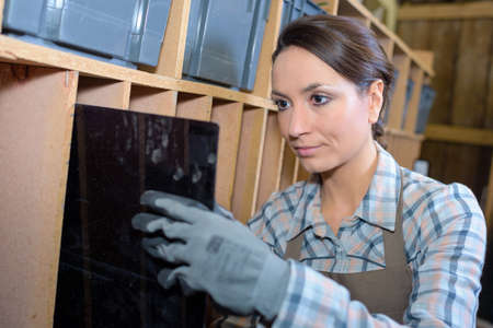 Artist in gloves holding black sheetの写真素材