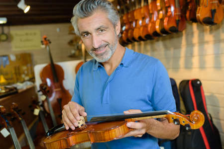 luthier mending a violinの写真素材