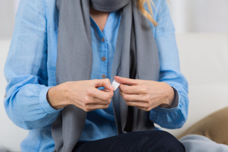 mature woman put plaster bandage on finger cut
