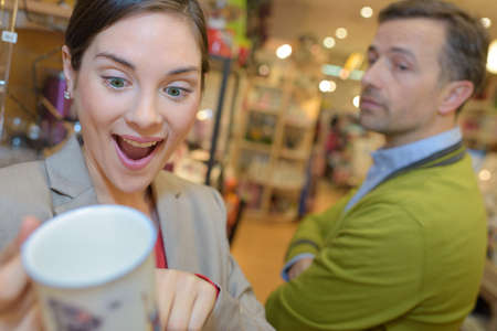 couple looking at items displayed in shopping in mallの写真素材