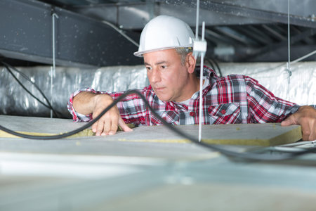 electrician fixing neon on the ceiling