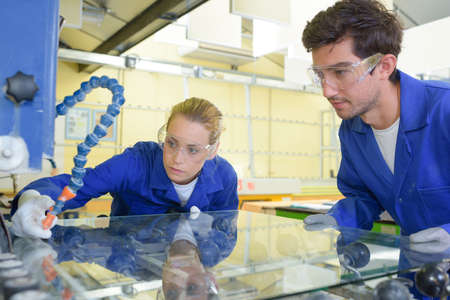 Man and woman in glass factoryの写真素材