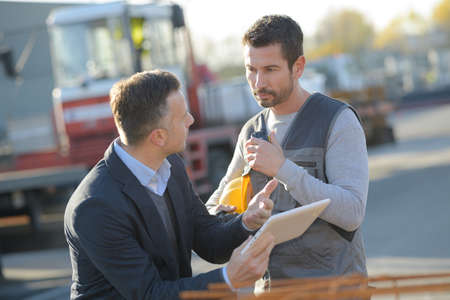 male engineer talks about working with a workerの写真素材