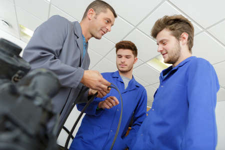 Man showing rubber component to studentsの写真素材