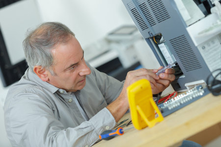 Senior technician using screwdriver