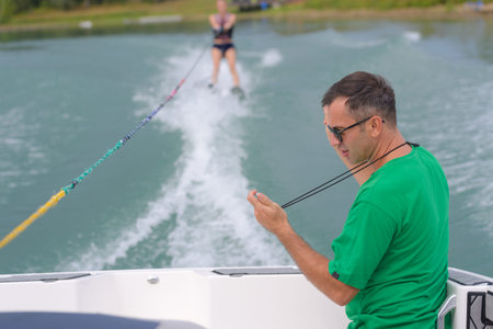 a water skier preforming water skiing sport on a lake