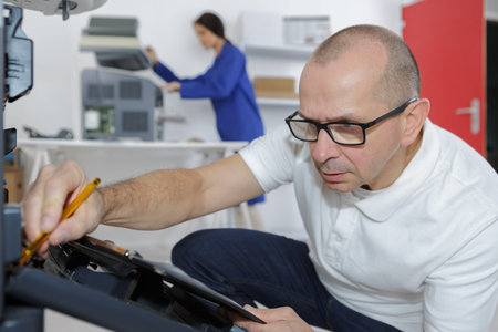 Technician working on photocopierの写真素材
