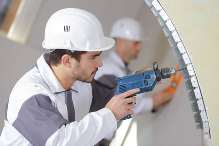 construction worker with tools and drill renovating house