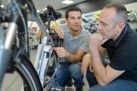 man client and seller discussing bike performances at bicycle store