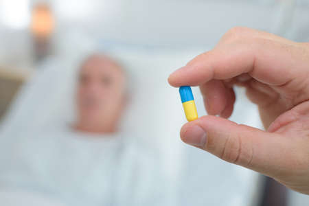 presenting a pill to patientの写真素材