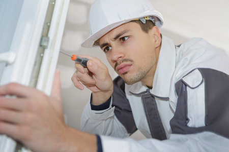 construction worker installing window