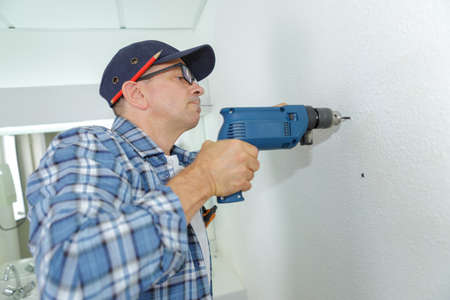 using a cordless drillの写真素材