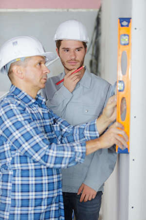 Man using spirit level verticallyの写真素材