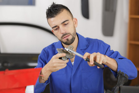 Mechanic working on car part
