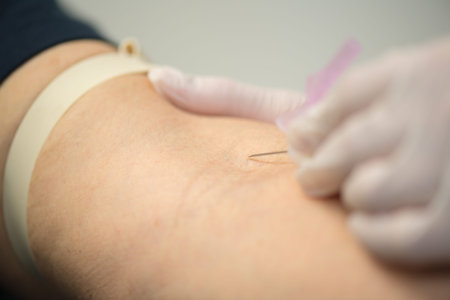 Needle being inserted into vein on arm