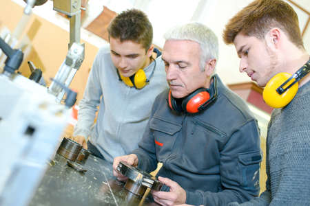 Three men with earmuffsの写真素材