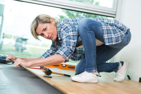 Middle aged woman fitting floorの写真素材