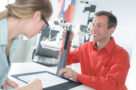 Optician showing text for patient to read