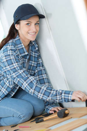 Portrait of woman fitting new flooringの写真素材