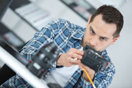 Man working on camera equipmentの写真素材