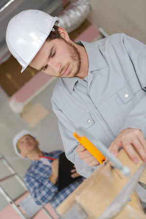 Young man using hack saw