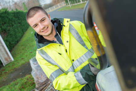Portrait of young man in high visability coatの写真素材
