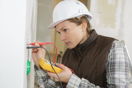female electrician calibrating a home socket