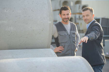 engineers checking cement pipesの写真素材