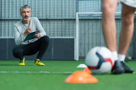 football coach training football playerの写真素材