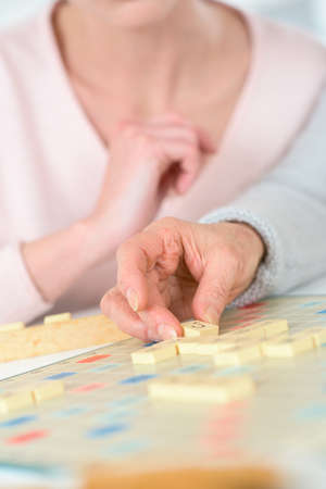woman and senior playing word puzzle gameの写真素材