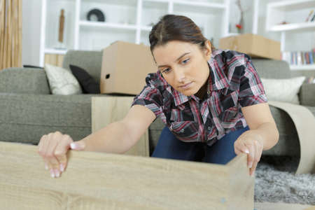 woman with self assembly furnitureの写真素材