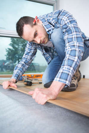 man laying parquet at homeの写真素材