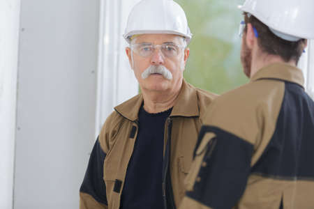 two builders having a conversationの写真素材