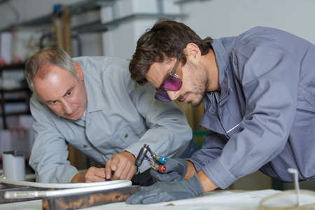 young man in professional training to become plumberの写真素材