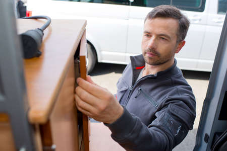 fitting wardrobe hinge doors in kitchen cabinetの写真素材