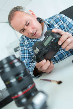 photographer cleaning cameraの写真素材