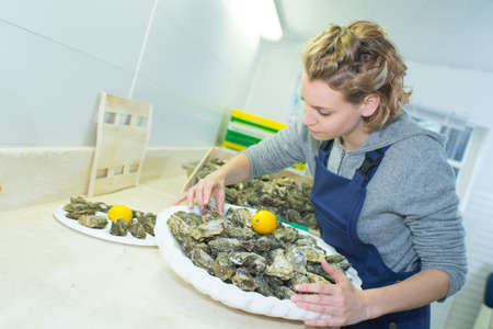 woman holding an oyster trayの写真素材