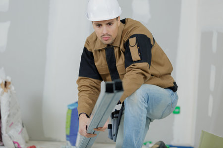 young metalworker controls some metal bars in steel mill