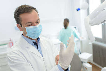 putting the disposable glovesの写真素材