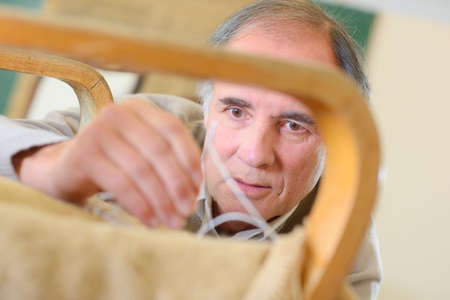 upholsterers hands restoring antique upholsteryの写真素材