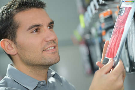 happy hansome man buying in a shopping mallの写真素材