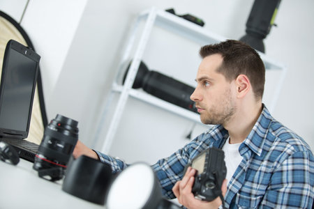 photographer working checking photos on laptopの写真素材