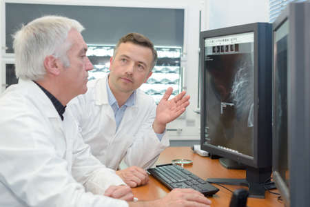 doctors are analyzing echography on computerの写真素材