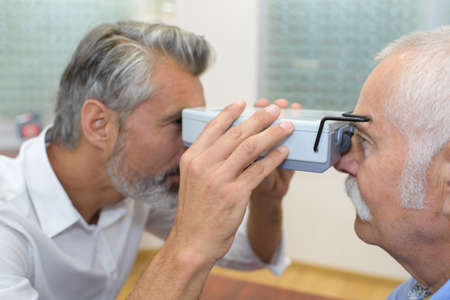 doctor optometrist at work with the device for testing visionの写真素材