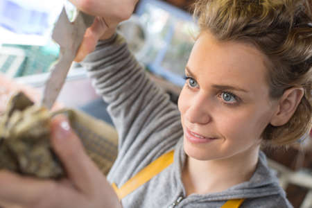 horizontal portrait of a young cheerful woman customer choosing productsの写真素材